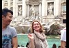 A tourist at the Trevi Fountain in Rome.